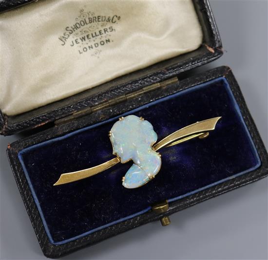 An 18ct gold and white opal brooch, the white opal carved as the bust of a lady to dexter, 50mm.